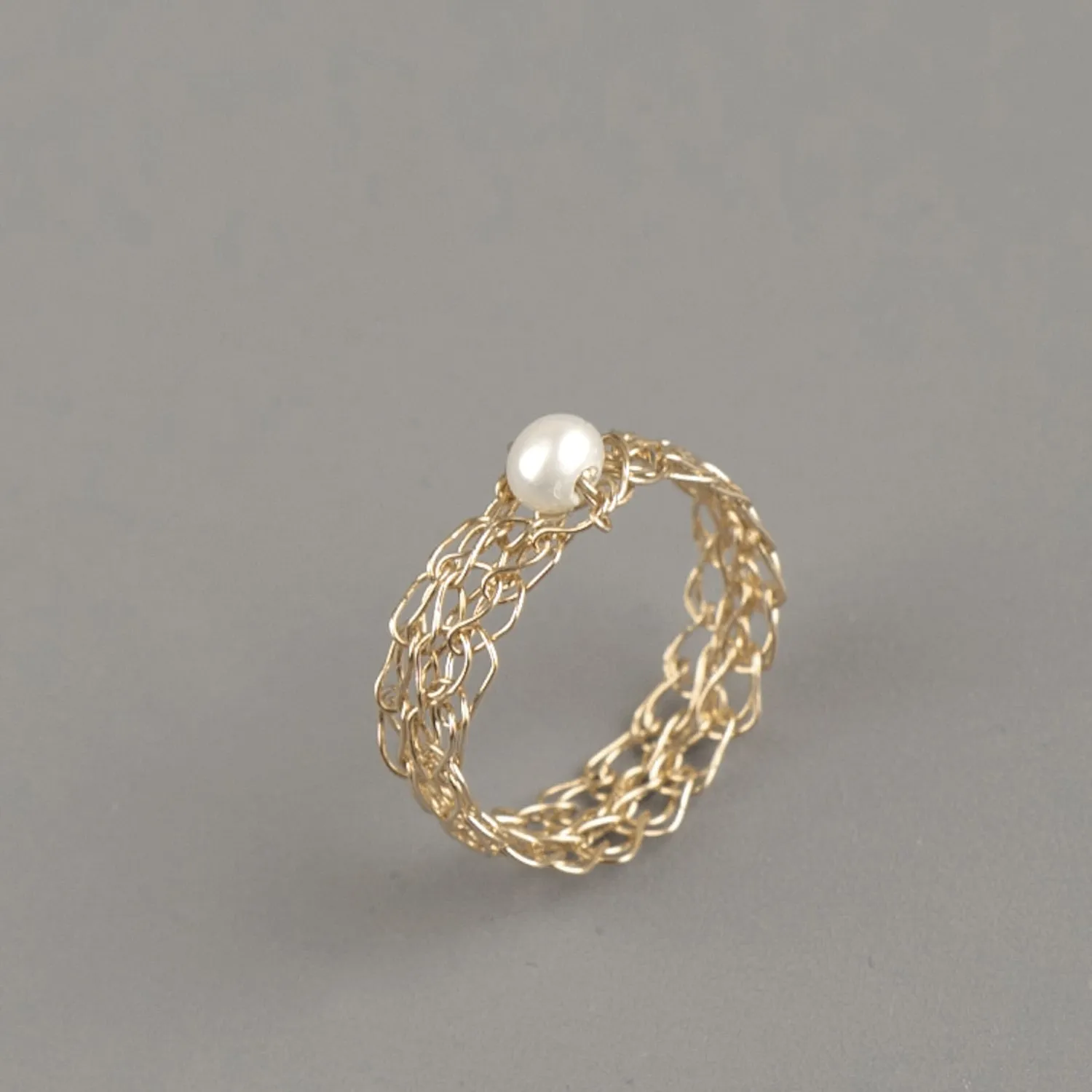 Thin gold ring with a pearl